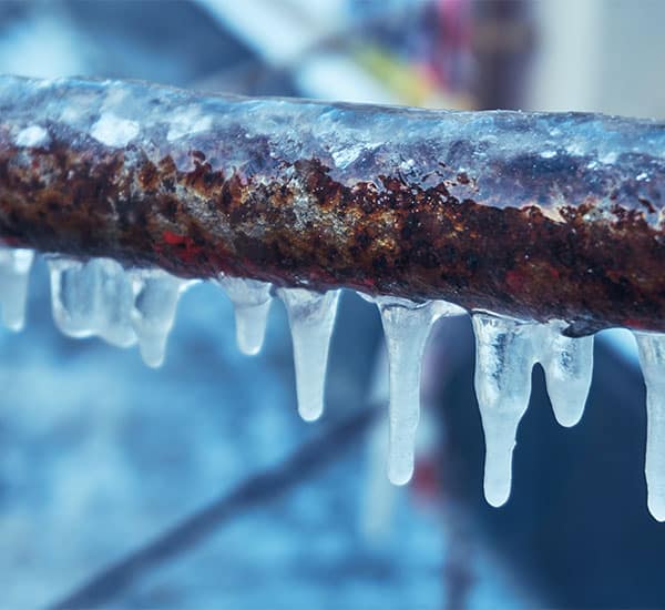 icecicles form on a frozen copper pipe